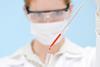 Woman with pipette doing medical research