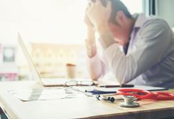 Stressed doctor with stethoscope